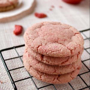 Strawberry sugar cookies on rack and plate