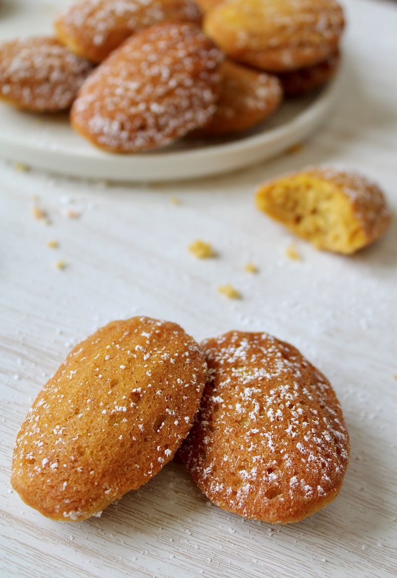 Pumpkin spice madeleines with cake crumbs on table